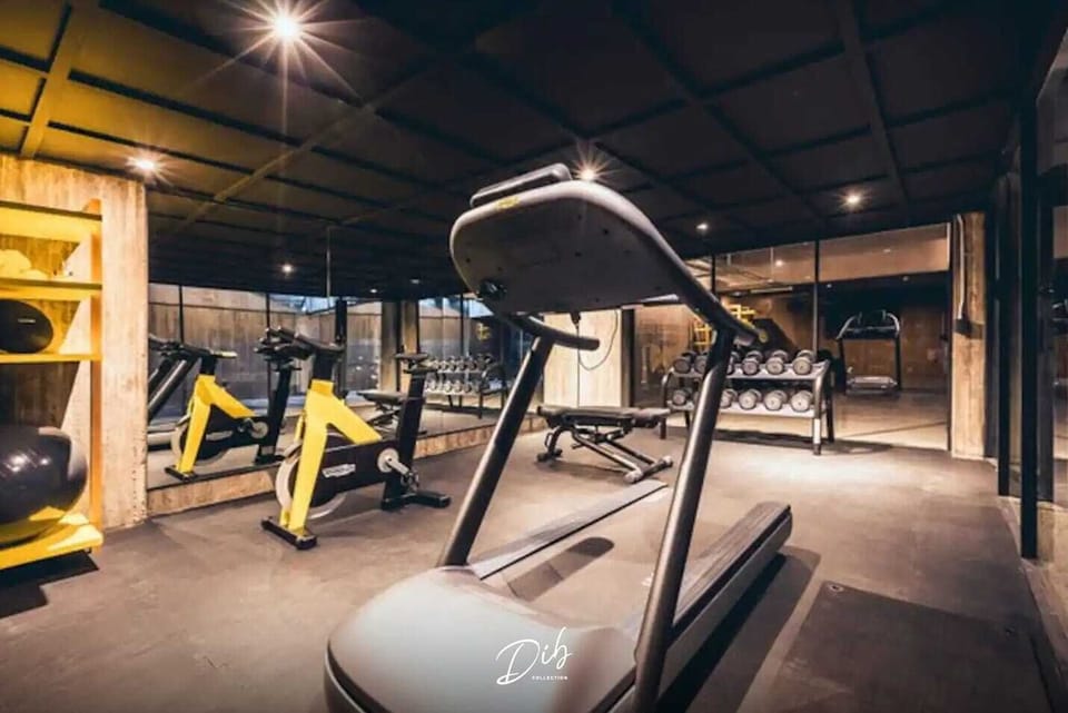 The building gym includes cardio equipment and free weights for maintaining your fitness routine.