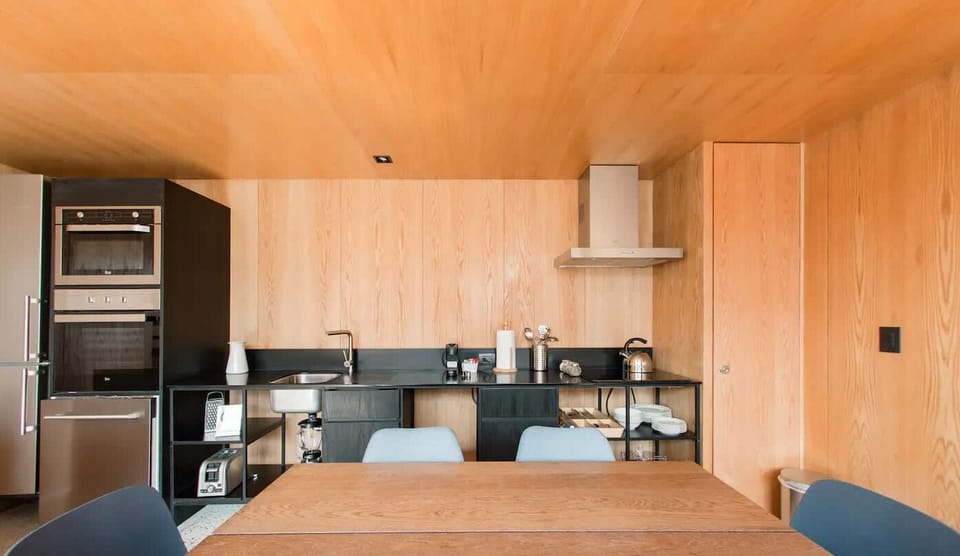Long dining table with seating for everyone—perfect for shared meals or spreading out your laptops.