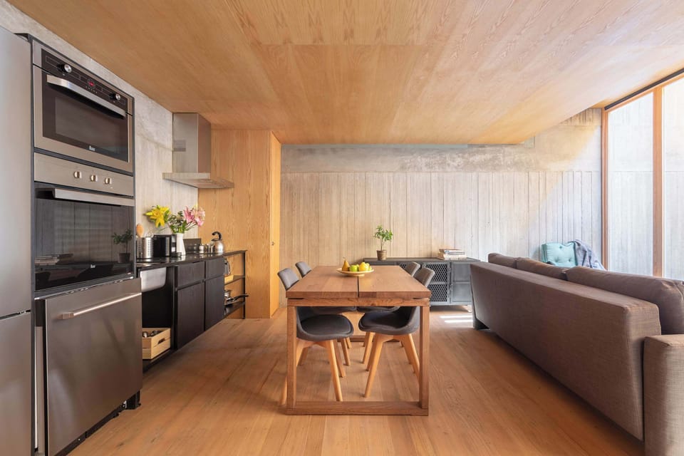 Your cozy living space seamlessly connects to dining and nature views outside.