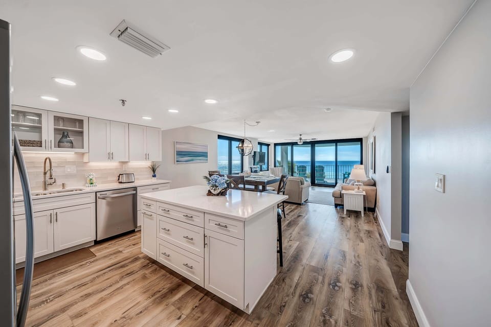 The beautifully updated, fully equipped kitchen features quartz countertops and stainless-steel appliances.