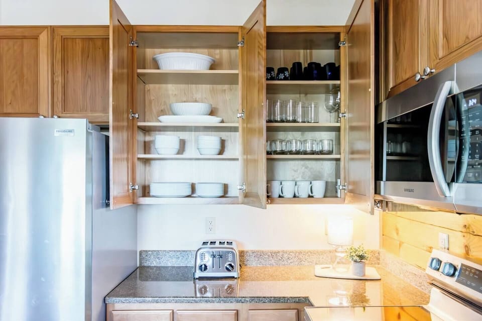 Kitchen is stocked with dishware, glasses, pots/pans, and everything needed to cook meals!