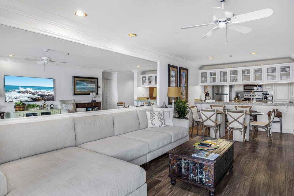 Relax in your open-plan living space where coastal comfort meets modern elegance, complete with ocean views on screen.