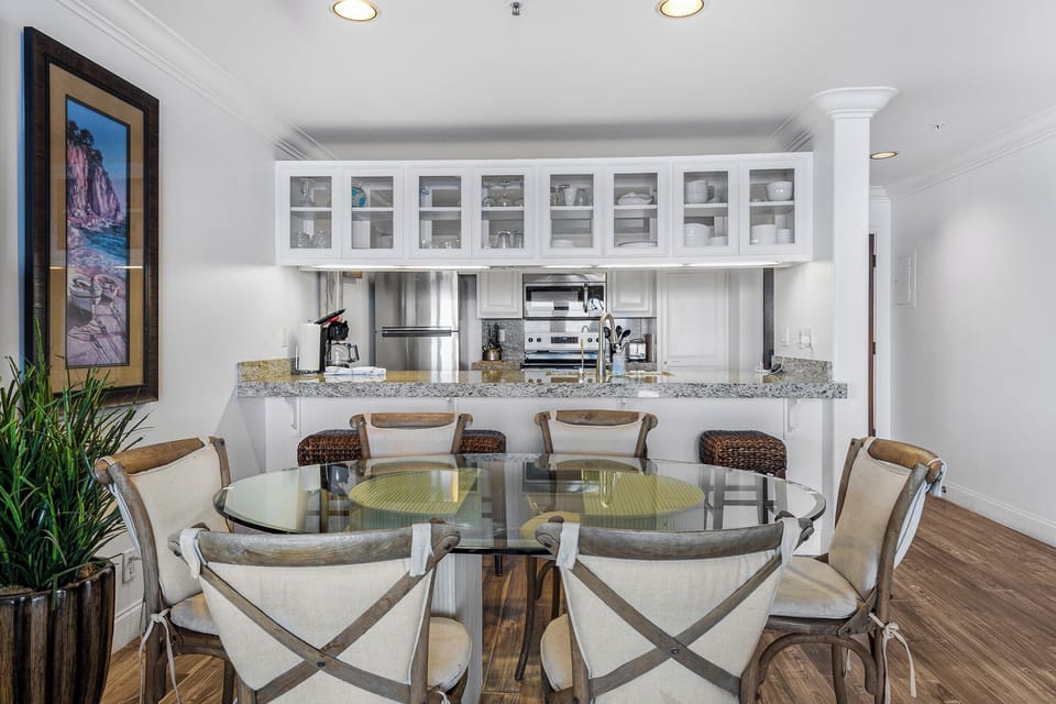 Your open kitchen flows seamlessly into the dining space, where granite counters and glass-front cabinets create an elegant backdrop for memorable meals together.