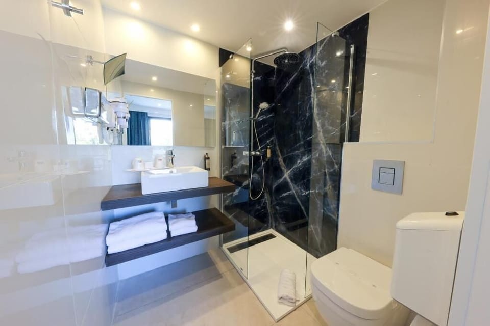 Shower, rainfall showerhead, hair dryer, towels