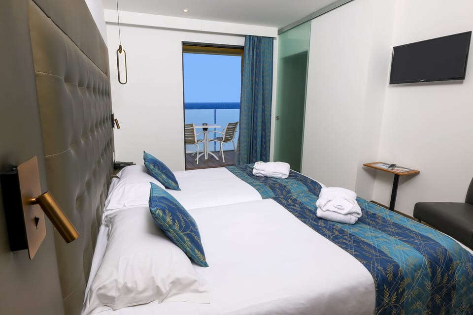 Superior Twin Room, Partial Sea View | Minibar, in-room safe, desk, soundproofing