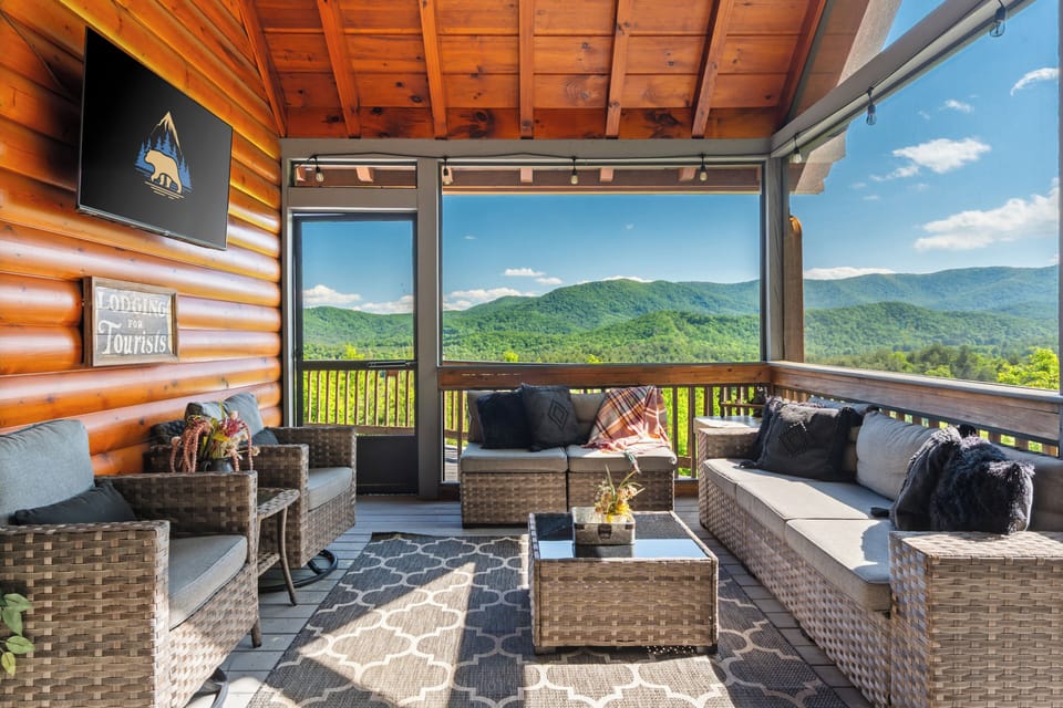 Screened in porch with gas fireplace, outdoor TV, and a view!