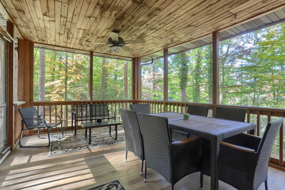 Screened-in porch with ceiling fan, outdoor dining table
