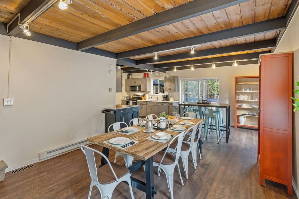 Seating for 12. Contemporary farmhouse dining set for 8 with a secondary bar height dining table set for 4 stools. You can find an additional set of 4 bar-height stools and tables in the game room for additional seating and table space.