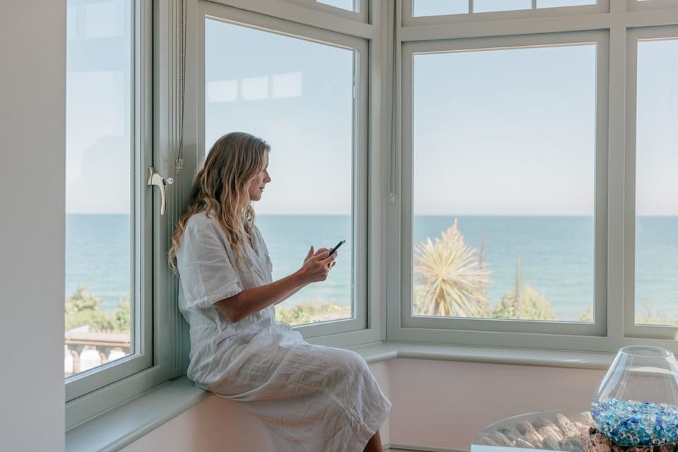 Woman on the digital tablet at The Croft, Coverack, Cornwall, self catering with Beach Retreats.