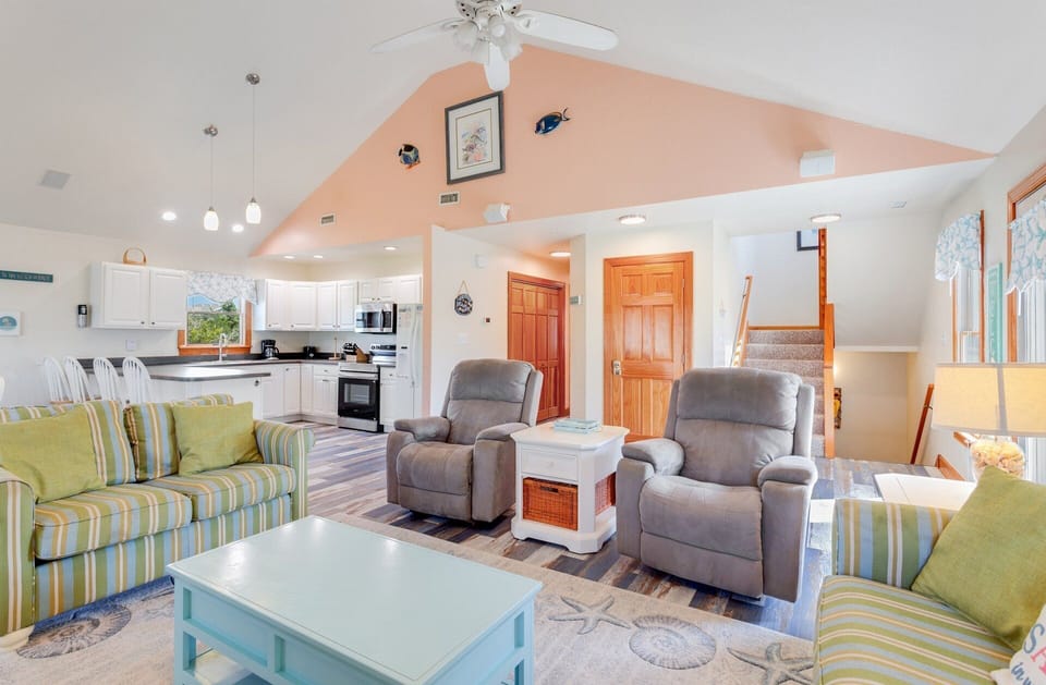Relax on the comfy furniture in front of the large, Flat Screen TV beneath the high ceilings!
