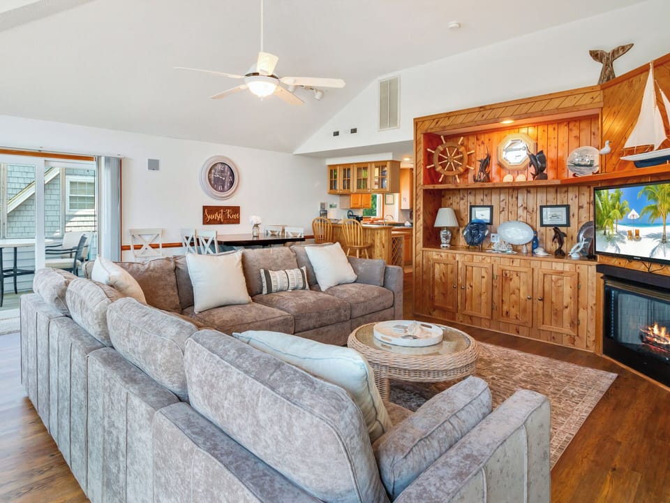 Beautiful Living Area with a Fireplace and deck access for family gatherings and planning your Outer Banks adventures!