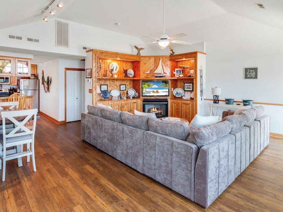 Open-concept Living Area with wooden floors and a fireplace for ultimate relaxation!