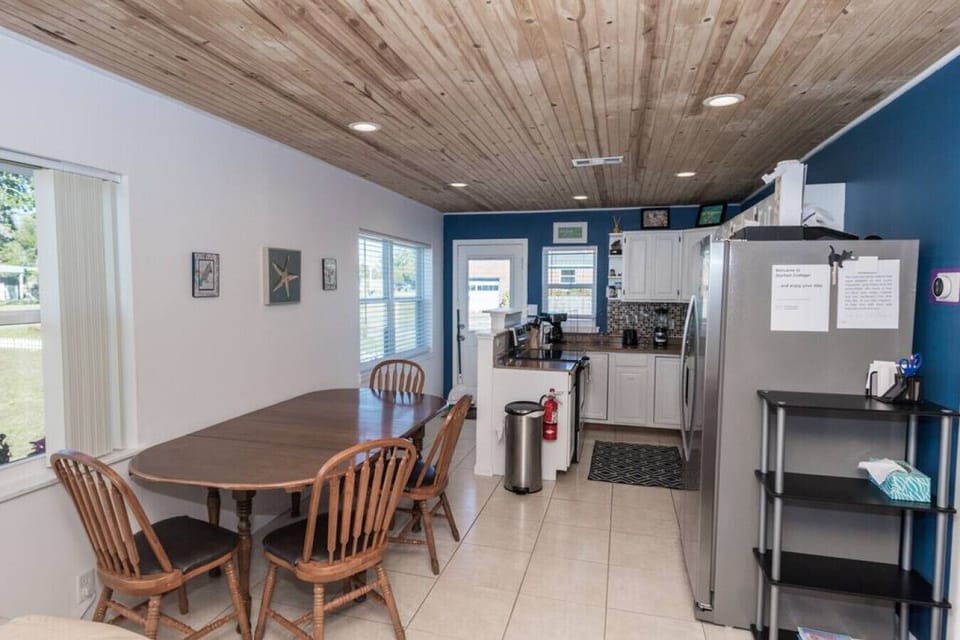 Dining Room: Bright and airy space for meals, featuring a charming wooden table and sunny views!