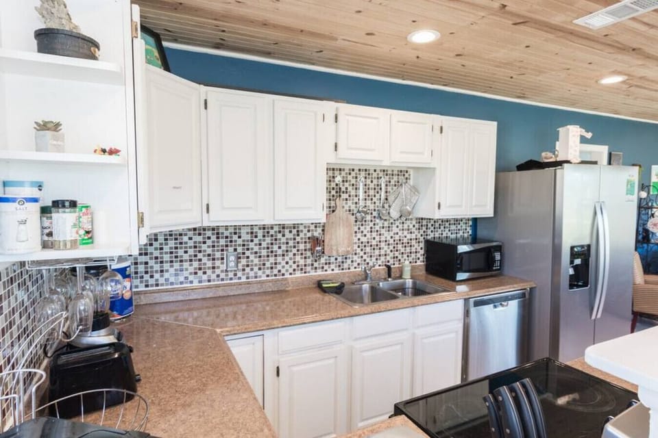 Kitchen: Whip up delicious meals in this modern kitchen with vibrant decor and sleek appliances!