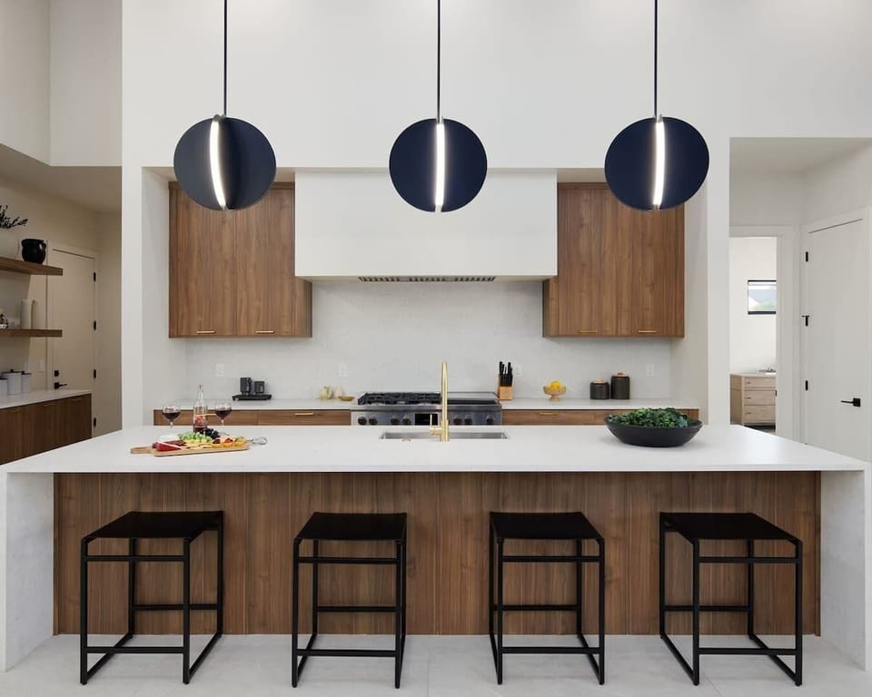 Fully equipped chefs kitchen featuring a colossal kitchen island offering an abundance of counter space with bar seating, high-end stainless steel appliances and stocked with all culinary essentials.