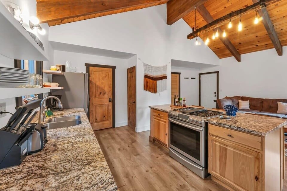 Prepare culinary delights while chatting with your group hanging out in the living room, the open layout of the home keeps you central to it all!