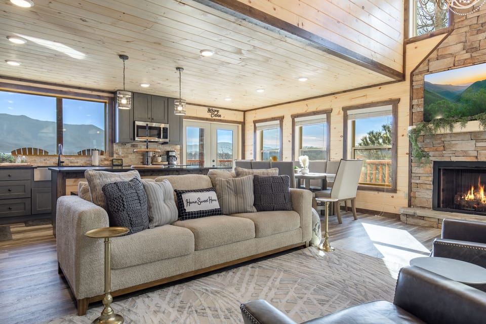 Relax together on comfy sofas while watching the fire and mountain views.

