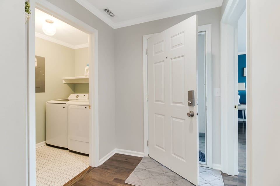 Front door to the condo from inside the Unit with laundry room to the left