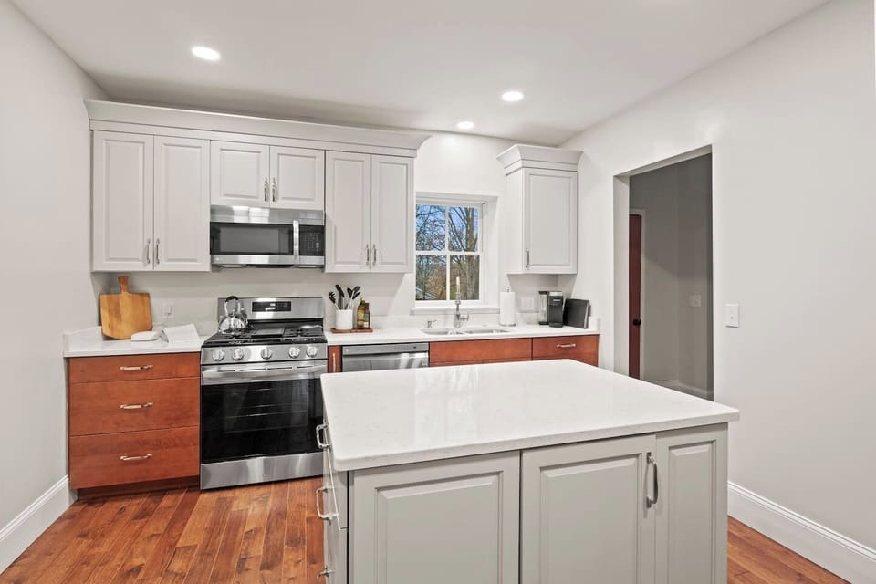 Unit #1 (1 of 3,  Ground Floor) Cook up a feast in this modern kitchen featuring stainless steel appliances and a spacious island. ️‍✨
