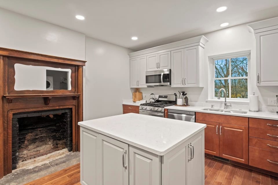 Unit #1 (1 of 3,  Ground Floor) Cook up a feast in this modern kitchen featuring stainless steel appliances and a spacious island. ️‍✨