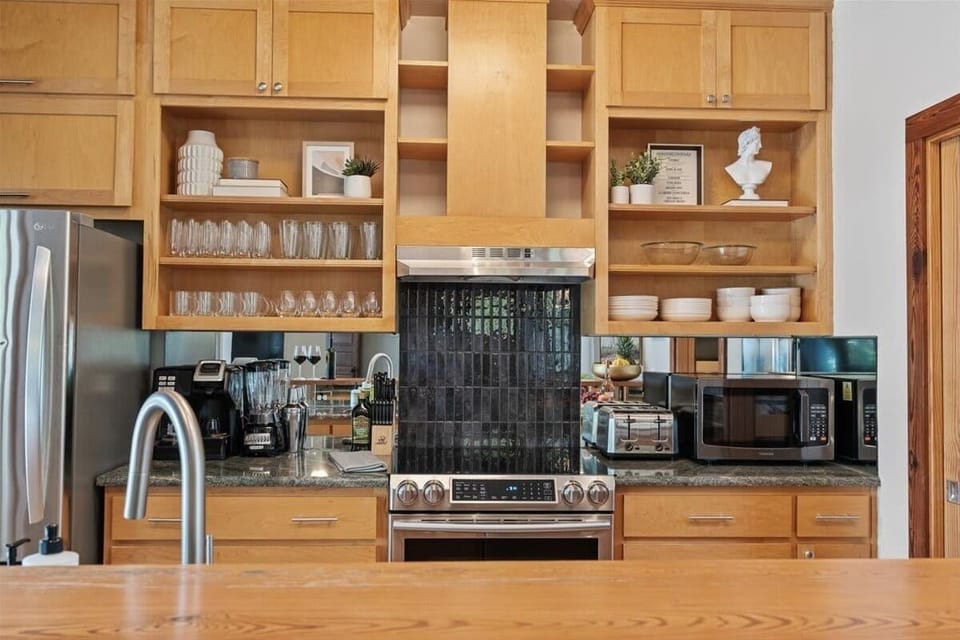 Cooking made easy and stylish—wooden cabinets and all the essentials for your perfect stay.