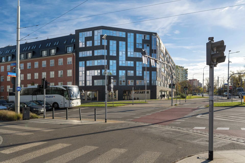 Another view of the modern apartment building, highlighting the clean lines and geometric design of the exterior.