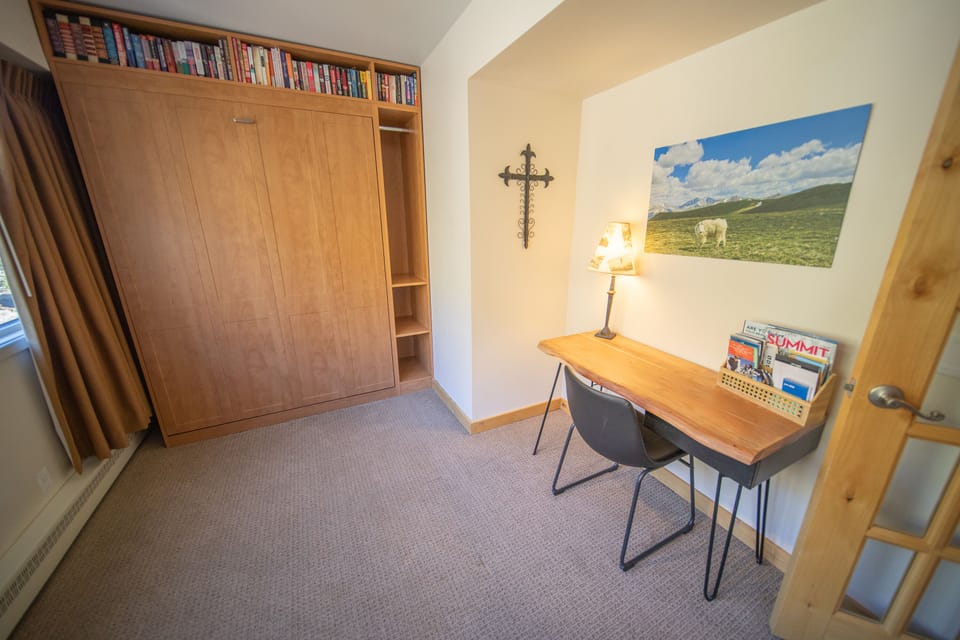 Office desk and folded up Murphy bed