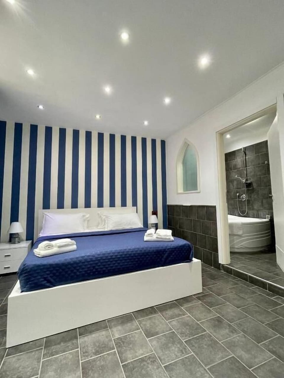 Deluxe Quadruple Room | In-room safe, desk, laptop workspace, iron/ironing board