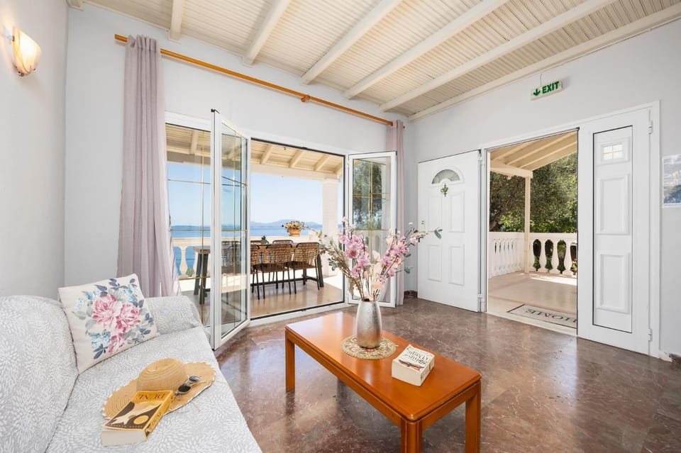 Open-plan living room with sofas, dining area, kitchen, ornamental fireplace, WiFi internet, and satellite TV