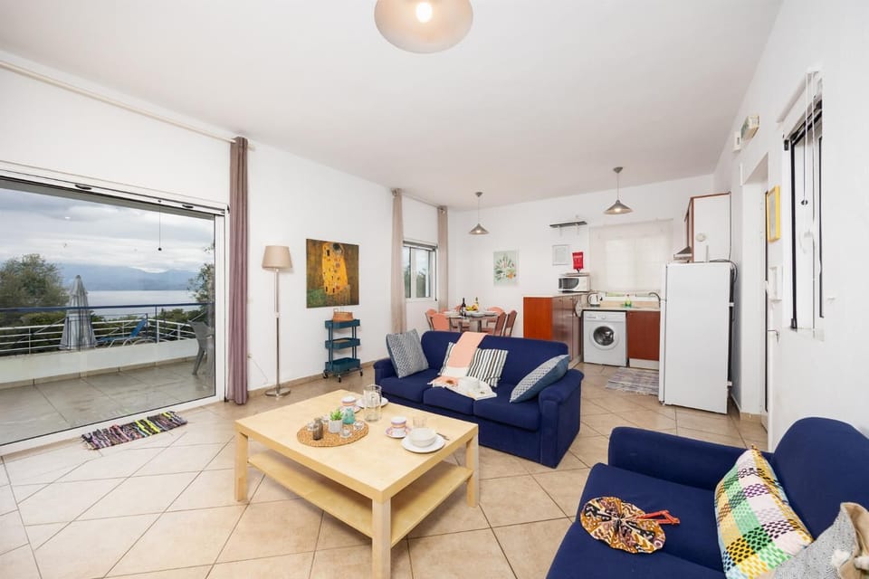 Open-plan living room with sofas, dining area, ornamental fireplace, WiFi internet, and satellite TV