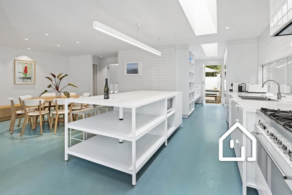 A well-equipped industrial-style kitchen, between the living room and pool area