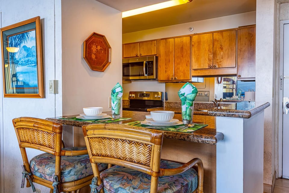 Gather around your inviting breakfast bar with tropical-inspired seating and a fully equipped kitchen ready for your home-cooked island meals.