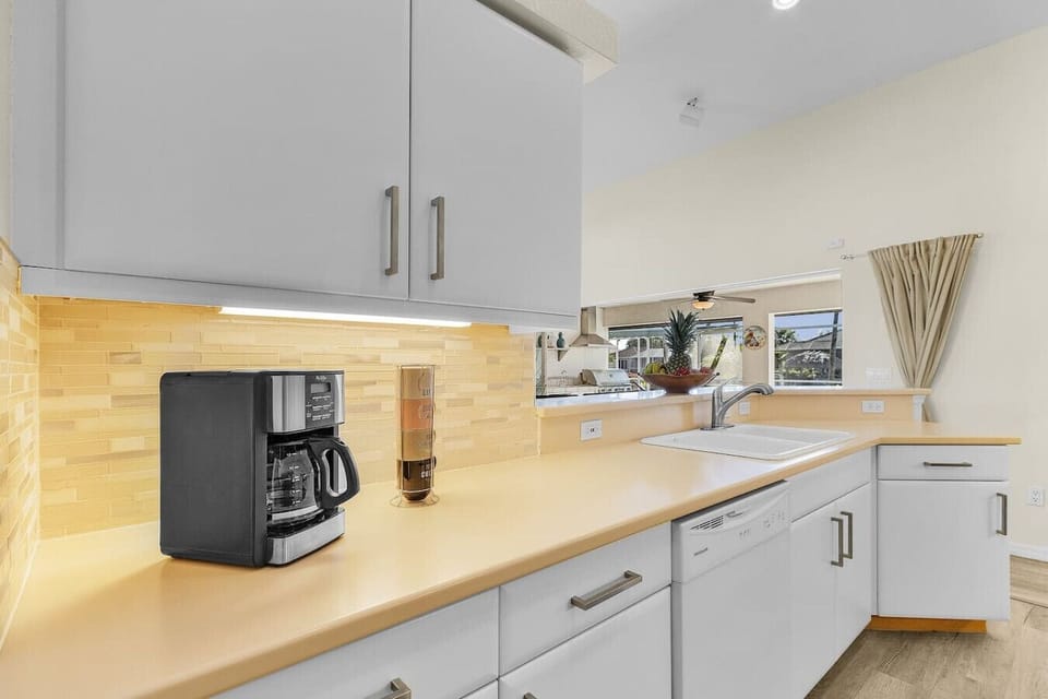 Start your mornings right with a dedicated coffee station, ample counter space, and stylish finishes throughout the kitchen.