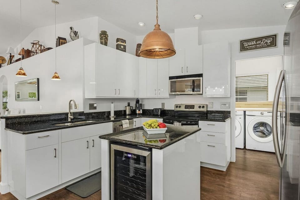 Fully equipped modern kitchen with sleek finishes and stainless-steel appliances.