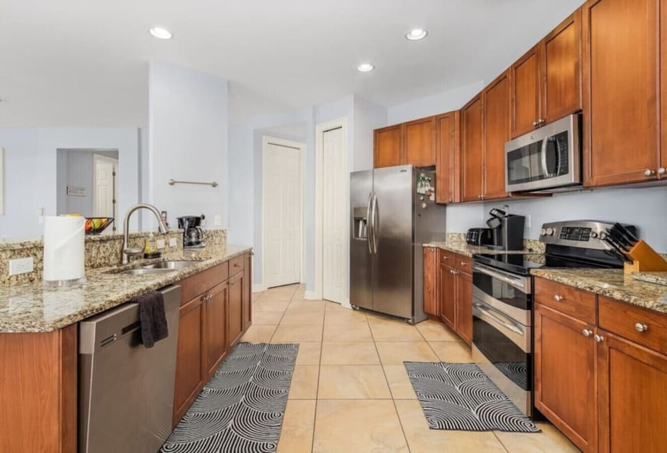 Modern kitchen with granite countertops and stainless steel appliances for gourmet cooking.