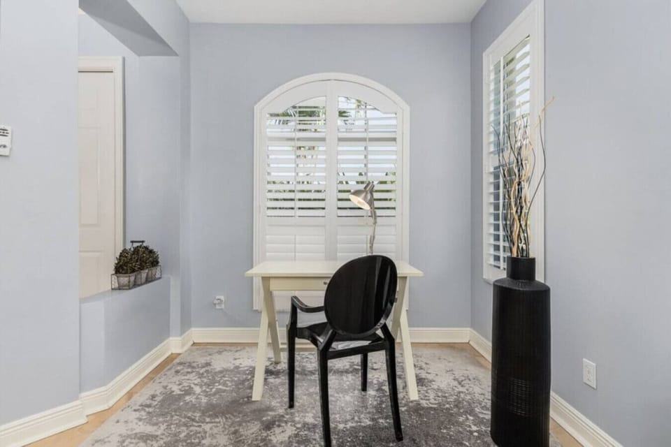 Cozy home office with natural light and stylish decor for productive work sessions.