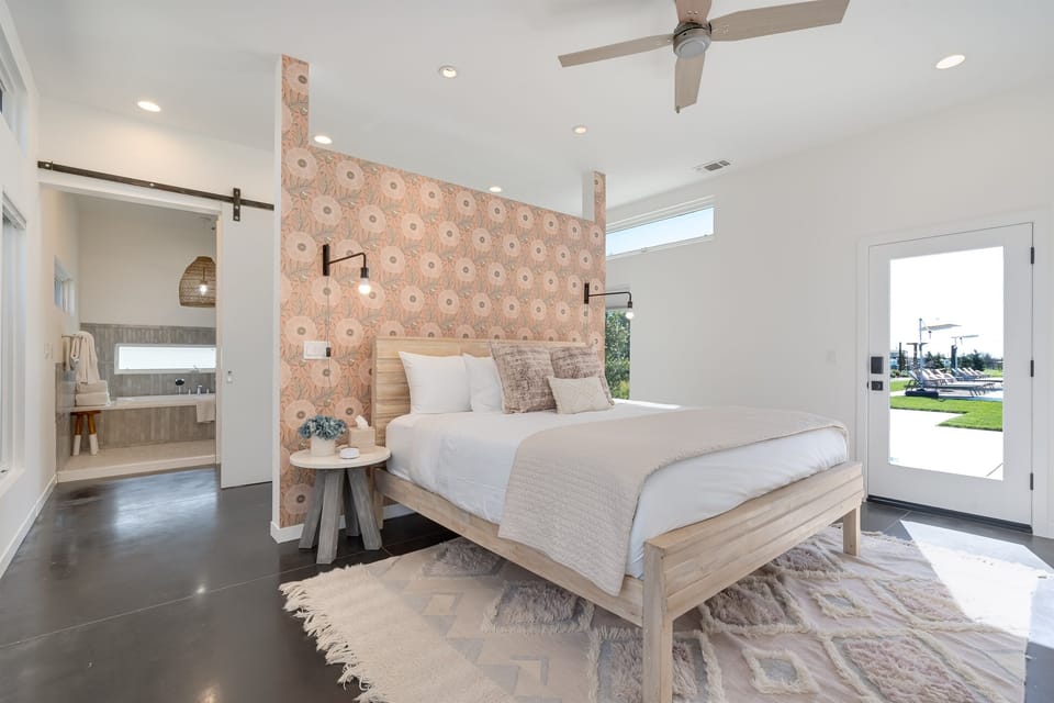 Primary Bedroom: Bright and airy retreat with modern decor and direct access and serene outdoor views.