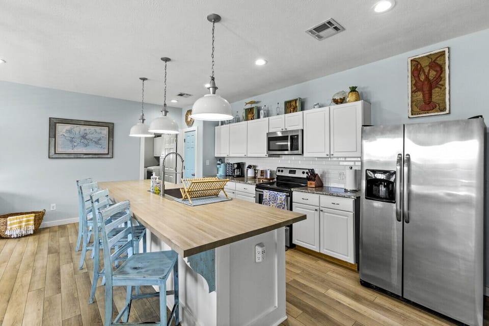Modern kitchen with a large island and seating, ideal for social cooking.