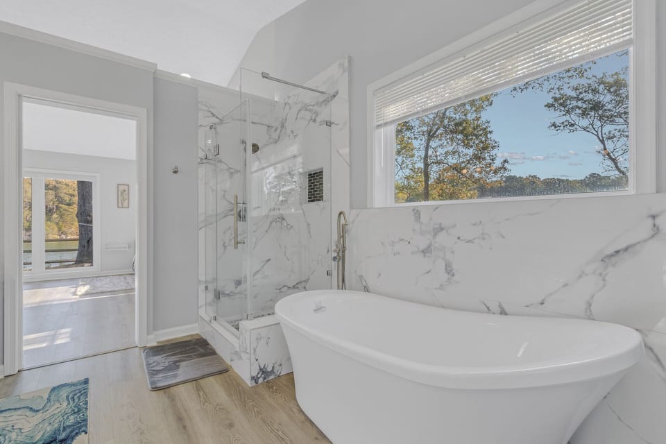 Soaking tub and beautiful blue pebbled shower.