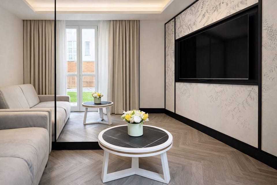Luxury Suite | Living area | 42-inch Smart TV with satellite channels