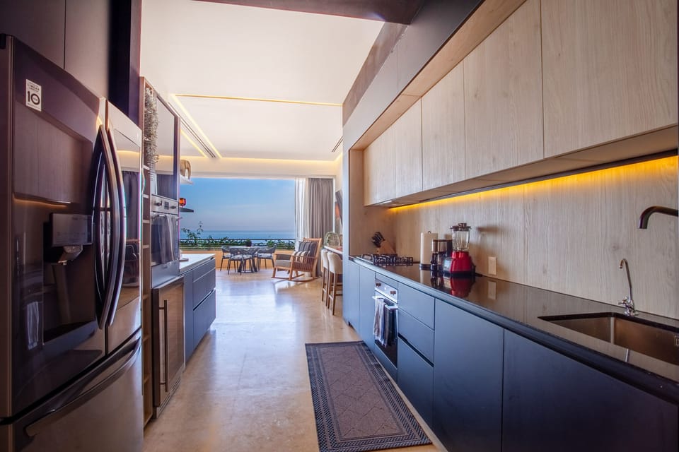 Indulge in the breathtaking view as you prepare culinary delights in the kitchen
