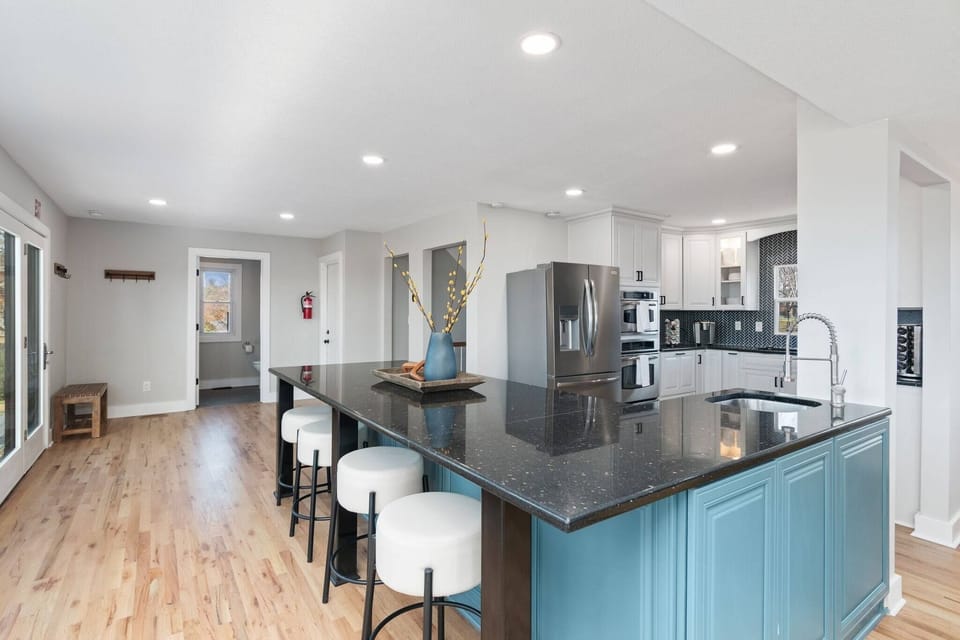 kitchen (behind you is the dining area, behind you to the right is the living area, and at the opposite end of the room is a half-bath with laundry)