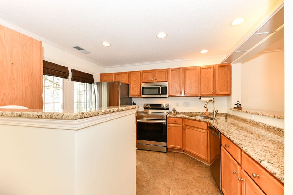 Full kitchen- stainless steel appliances including dish washer & coffee station.
