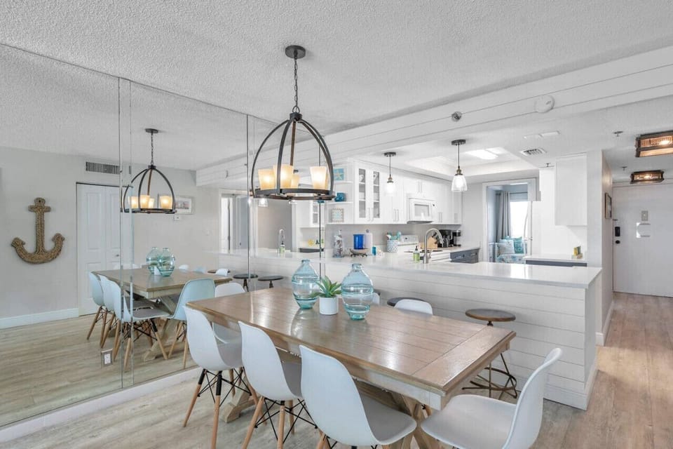 Airy dining area set under a statement light, perfect for shared meals and easy conversation.