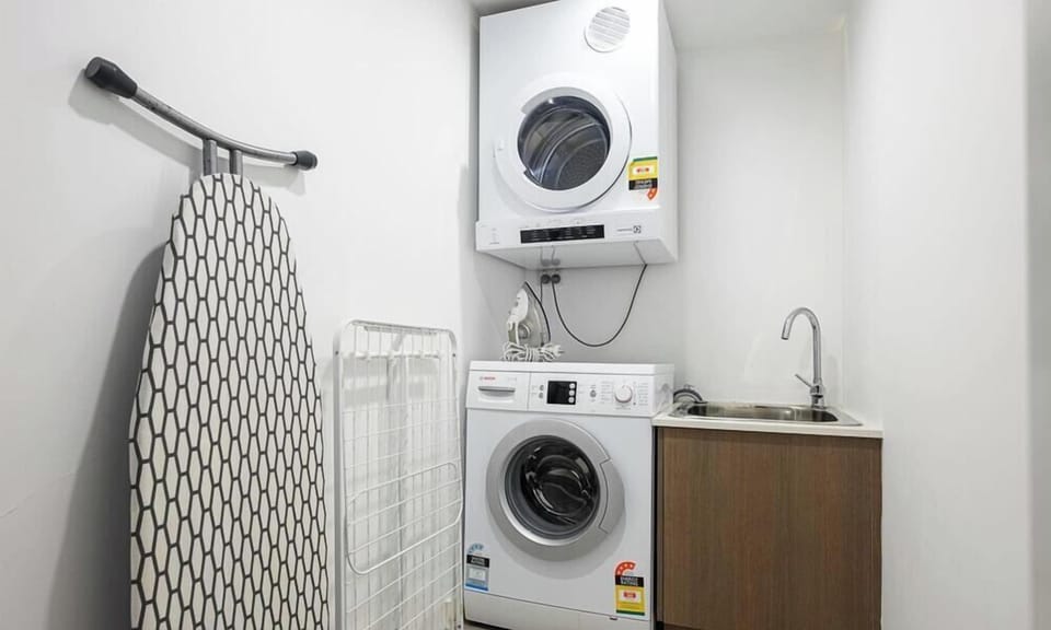 Internal laundry with washing machine, dryer, and ironing facilities.