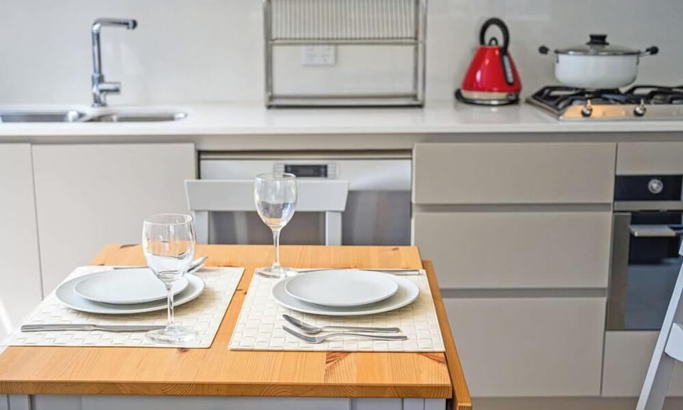 Kitchen and dining setup with breakfast bar and fully equipped cooking facilities.