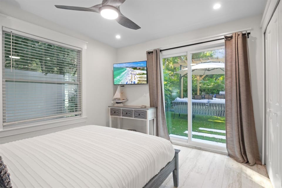 Bright & Tranquil QUEEN Bedroom: Bedroom bathed in natural light and offers serene views of the private yard through sliding doors, blending indoor comfort with outdoor beauty.