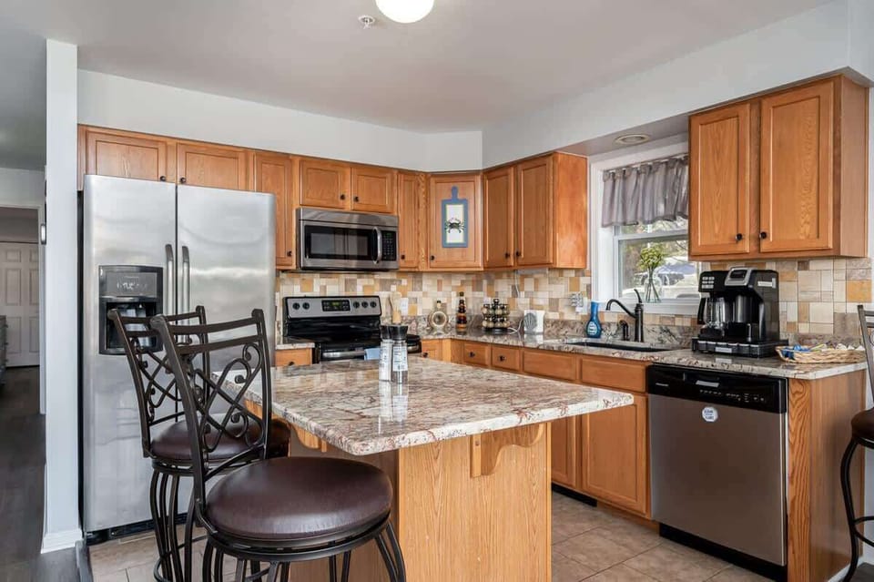 In addition to the dining area, there is seating for 2-3 people at the kitchen bar.