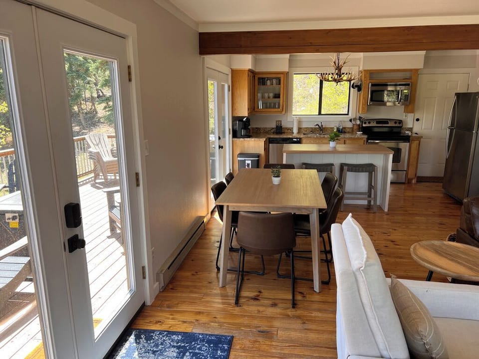 View of kitchen from living area. Dining table seats 6 + 2 barstools at island