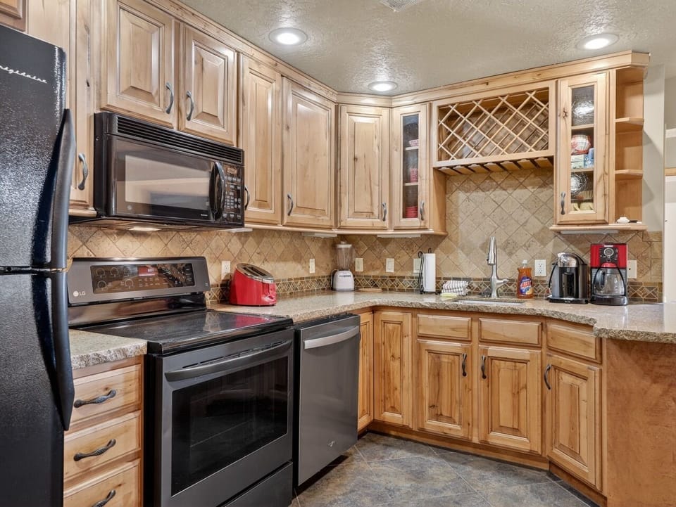 Cook memorable meals in your fully-equipped kitchen with beautiful wood cabinetry, granite counters, and modern appliances.